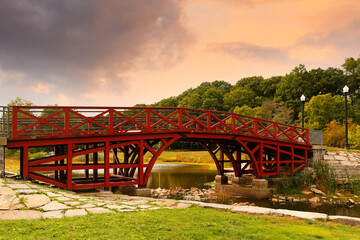 Red Wood bridge at Elm Park at sunset in Worcester, Massachusetts. Elm Park is an historic park in Worcester, Massachusetts