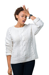 Beautiful young african american woman wearing sweater over isolated background surprised with hand on head for mistake, remember error. Forgot, bad memory concept.