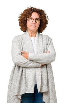 Beautiful middle ager senior woman wearing jacket and glasses over isolated background skeptic and nervous, disapproving expression on face with crossed arms. Negative person.