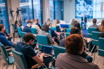 Businesspeople watching presentation in evening