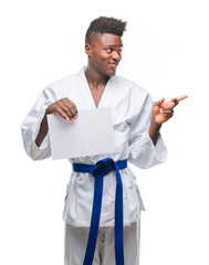 Young african american man over isolated background wearing kimono holding paper very happy pointing with hand and finger to the side