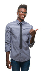 Young african american business man over isolated background smiling with happy face looking and pointing to the side with thumb up.