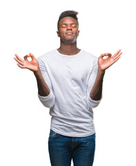 Fototapeta premium Young african american man over isolated background relax and smiling with eyes closed doing meditation gesture with fingers. Yoga concept.