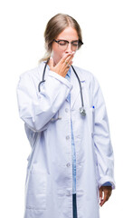 Beautiful young blonde doctor woman wearing medical uniform over isolated background bored yawning tired covering mouth with hand. Restless and sleepiness.