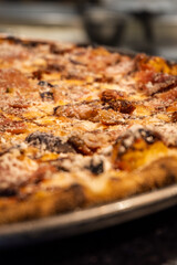 Italian food - pizza with salami, cheese and tomatoes, close-up