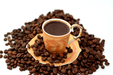 A cup of Turkish coffee with coffee beans, seeds of the Coffea plant and the source for coffee. It...