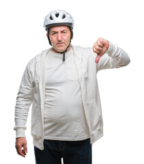 Handsome senior cyclist man wearing bike helmet over isolated background with angry face, negative sign showing dislike with thumbs down, rejection concept