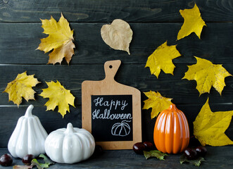 Autumn still life on a wooden background autumn leaves and berries, decorative pumpkins symbol of...