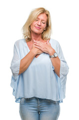 Middle age blonde business woman over isolated background smiling with hands on chest with closed eyes and grateful gesture on face. Health concept.