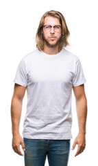 Fototapeta premium Young handsome man with long hair wearing glasses over isolated background puffing cheeks with funny face. Mouth inflated with air, crazy expression.