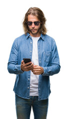 Young handsome man with long hair over isolated background sending message using smartphone with a confident expression on smart face thinking serious