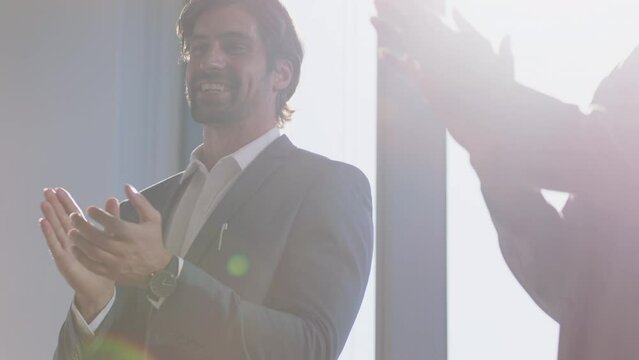 Hands, applause and support with a business man clapping for the goal, target or success of a colleague in the office. Teamwork, event and celebration with a male employee in solidarity with his team