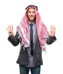 Young handsome arabian man with long hair wearing keffiyeh over isolated background showing and pointing up with fingers number nine while smiling confident and happy.