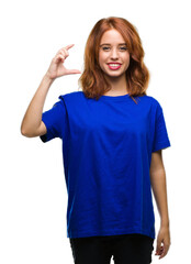 Young beautiful woman over isolated background smiling and confident gesturing with hand doing size sign with fingers while looking and the camera. Measure concept.