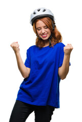Young beautiful woman wearing cyclist helmet over isolated background very happy and excited doing winner gesture with arms raised, smiling and screaming for success. Celebration concept.