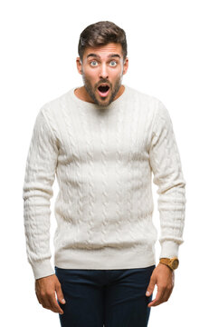 Young handsome man wearing winter sweater over isolated background afraid and shocked with surprise expression, fear and excited face.