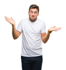 Young handsome man wearing glasses over isolated background clueless and confused expression with...