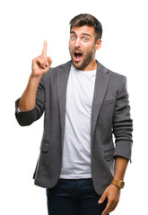 Young handsome business man over isolated background pointing finger up with successful idea. Exited and happy. Number one.