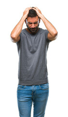 Fototapeta premium Adult hispanic man over isolated background suffering from headache desperate and stressed because pain and migraine. Hands on head.