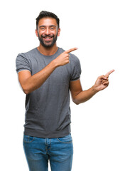 Adult hispanic man over isolated background smiling and looking at the camera pointing with two...