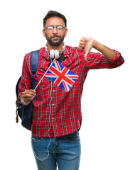 Adult hispanic student man holding passport of united kingdom over isolated background with angry face, negative sign showing dislike with thumbs down, rejection concept