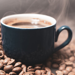 A cup of coffee with beans scattered nearby