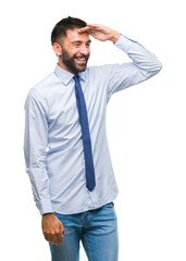 Adult hispanic business man over isolated background very happy and smiling looking far away with hand over head. Searching concept.