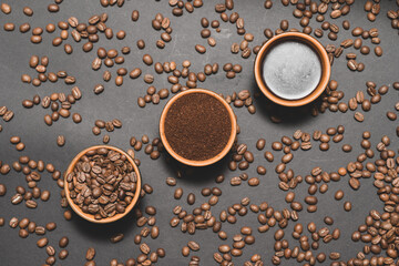 Three cups with different coffee, coffee beans, ground and ready-made drink.