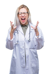Young blonde doctor woman over isolated background celebrating mad and crazy for success with arms...