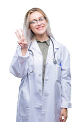 Young blonde doctor woman over isolated background showing and pointing up with fingers number three while smiling confident and happy.