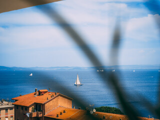 A dreamy shore view of the regatta participating sailing yachts in Argentario, Italy
