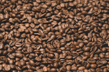 Texture of roasted coffee beans close-up, brown beans.