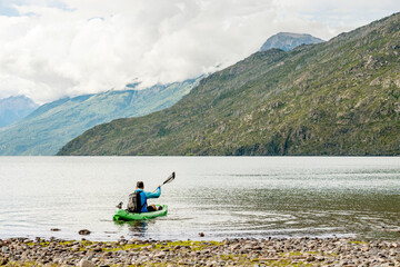 Rear view of a man paddling kayak in lake