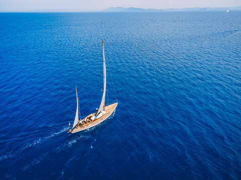 Top view of the two-masted sailing vessel in the bay in Tuscany, Italy