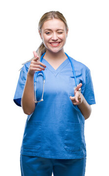 Young blonde surgeon doctor woman over isolated background pointing fingers to camera with happy and funny face. Good energy and vibes.