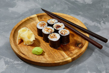 Traditional delicious freshsushi rolls with shrimp on a black background. Sushi roll with rice, cream cheese, avocado, salmon, sesame. Sushi menu. Japanese kitchen, restaurant