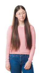 Obraz premium Young Chinese woman over isolated background wearing glasses smiling looking side and staring away thinking.