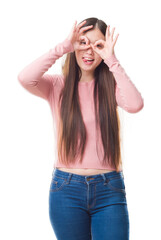 Obraz na płótnie Canvas Young Chinese woman over isolated background wearing glasses doing ok gesture like binoculars sticking tongue out, eyes looking through fingers. Crazy expression.