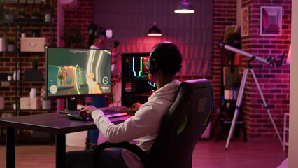 African american woman fighting in virtual reality game on console while boyfriend is playing...