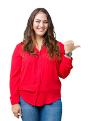 Beautiful plus size young business woman over isolated background smiling with happy face looking and pointing to the side with thumb up.