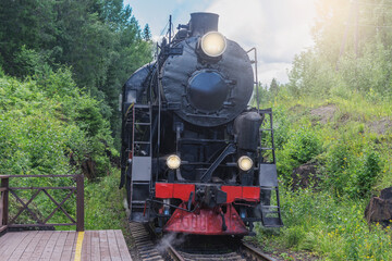 Retro steam train approaches to the platform.