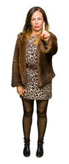 Beautiful middle age elegant woman wearing mink coat Pointing with finger up and angry expression