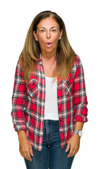 Middle age adult woman wearing casual shirt over isolated background afraid and shocked with surprise expression, fear and excited face.