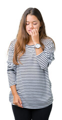 Young beautiful brunette woman wearing stripes sweater over isolated background looking stressed and nervous with hands on mouth biting nails. Anxiety problem.