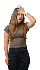 Fototapeta premium Young beautiful brunette woman over isolated background surprised with hand on head for mistake, remember error. Forgot, bad memory concept.