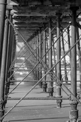 Black and white photo of steels supports underneath Saltburn pier - stock photo