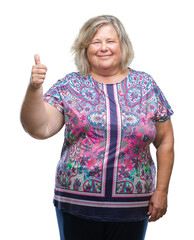 Senior plus size caucasian woman over isolated background doing happy thumbs up gesture with hand....