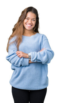 Young beautiful brunette woman wearing blue winter sweater over isolated background happy face smiling with crossed arms looking at the camera. Positive person.