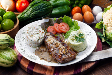 Beef steak with potatoes and rice