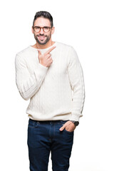 Young handsome man wearing glasses over isolated background cheerful with a smile of face pointing with hand and finger up to the side with happy and natural expression on face